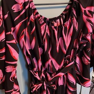 Black and pink Tyche dress with bell sleeves, ruffle bottom